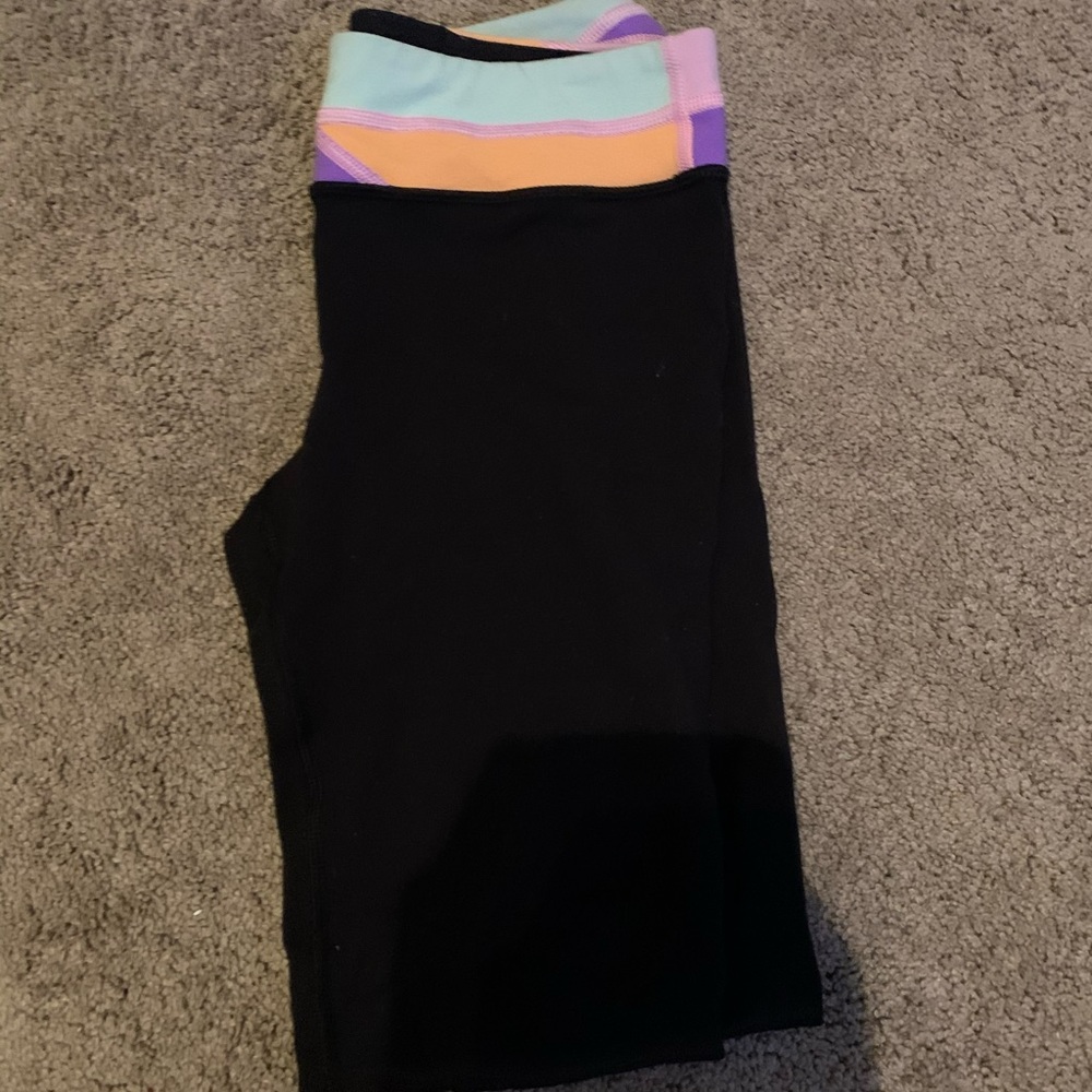 Black ivivva leggings with a patterned waist band